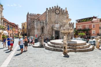 TAORMINA, ITALY - JUNE 29, 2017: people on Piazza dell Duomo near fountain in Taormina city. Taormina is resort town on Ionian Sea in Sicily
