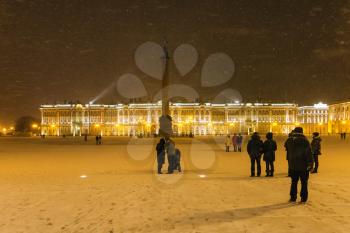Palace Square with Alexander Column and Winter Palace in Saint Petersburg city in night snowfall