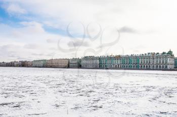 view of frozen Neva river and Dvortsovaya embankment in Saint Petersburg city in March