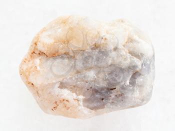 macro shooting of natural mineral rock specimen - rough marble stone on white marble background from Greece