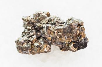 macro shooting of natural mineral rock specimen - pyrite stone on white marble background from Mexico