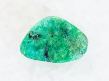 macro shooting of natural mineral rock specimen - piece of green Agate gemstone on white marble background from Mexico
