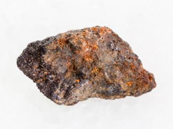 macro shooting of natural mineral rock specimen - raw Psilomelane (manganese ore) stone on white marble background