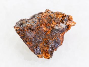 macro shooting of natural mineral rock specimen - rough Hematite (iron ore) stone on white marble background