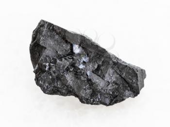 macro shooting of natural mineral rock specimen - rough Anthracite coal on white marble background