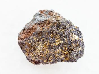 macro shooting of natural mineral rock specimen - raw magnetite (iron ore) stone on white marble background