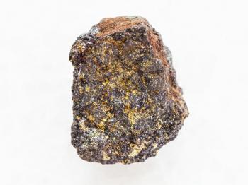 macro shooting of natural mineral rock specimen - rough magnetite (iron ore) stone on white marble background