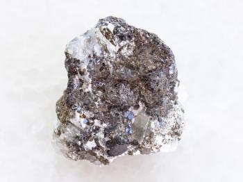 macro shooting of natural mineral rock specimen - raw sphalerite (zinc blende) stone on white marble background