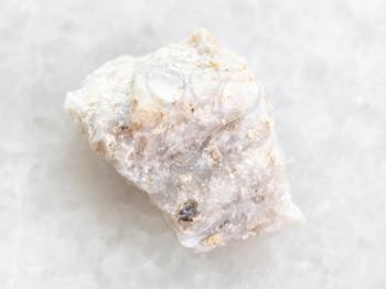 macro shooting of natural mineral rock specimen - raw Conglomerate stone on white marble background