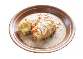 russian cuisine - stewed cabbage rolls on ceramic plate isolated on white background