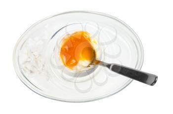 top view of soft boiled white egg with spoon in glass egg cup isolated on white background