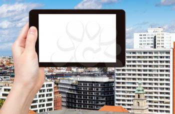 travel concept - tourist photographs Berlin city in Germany in september on tablet with cut out screen for advertising logo
