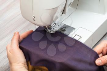workshop on sewing a patchwork scarf - designer sews bands of fabrics for the future silk shawl with sewing machine