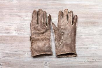 workshop on sewing gloves - top view of new hand-made stitched gloves on wooden background