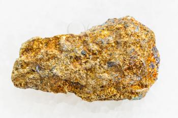 macro shooting of natural mineral rock specimen - raw pyrite ore on white marble background