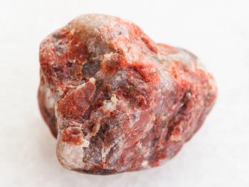 macro shooting of natural mineral rock specimen - Pegmatite stone on white marble background