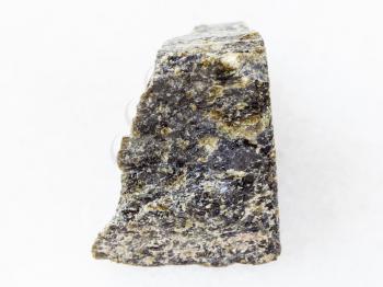 macro shooting of natural mineral rock specimen - raw Diopside stone on white marble background from Kovdor region, Kola Peninsula in Russia