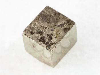 macro shooting of natural mineral rock specimen - pyrite crystal on white marble background from Spain