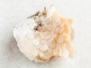 macro shooting of natural mineral rock specimen - rough Thomsonite stone on white marble background