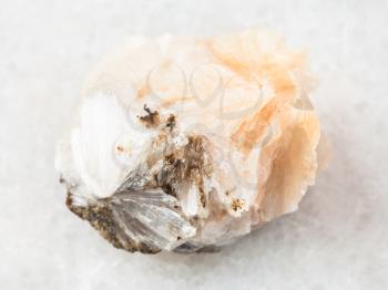 macro shooting of natural mineral rock specimen - raw Thomsonite stone on white marble background