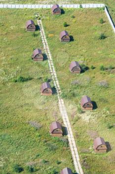 above view of several wooden houses in village in Moscow Region in Istrinsky district in summer day