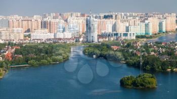 Above view of cottage village Beresta on island and modern residential district Pavshinskaya Poyma in Krasnogorsk town on waterfront of Picturesque Bay of Moskva River in Moscow suburb