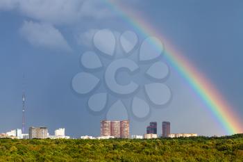 rainbow in rainy sky over Moscow city with TV tower and Timiryazevskiy urban park
