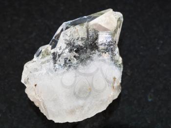 macro shooting of natural mineral rock specimen - rough rock-crystal of quartz gemstone on dark granite background