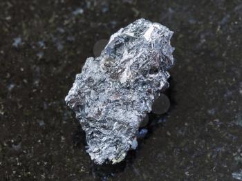 macro shooting of natural mineral rock specimen - raw hematite ore on dark granite background from Kazakhstan
