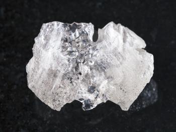 macro shooting of natural mineral rock specimen - rough crystal of Danburite gemstone on dark granite background from Dalnegorsk region, Primorsky Krai, Russia