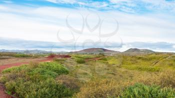 travel to Iceland - landscape with red volcanic soil near Kerid Lake in september