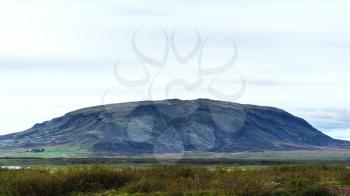 travel to Iceland - icelandic landscape with hill near Biskupstungnabraut road near Kerid lake in september evening