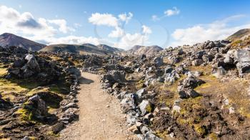travel to Iceland - path between rocks at Laugahraun volcanic lava field in Landmannalaugar area of Fjallabak Nature Reserve in Highlands region of Iceland in september