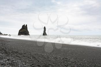 travel to Iceland - view of Reynisdrangar basalt stacks on Reynisfjara Beach in Iceland, near Vik I Myrdal village on Atlantic South Coast in Katla Geopark in september