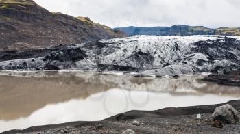 travel to Iceland - melting water and Solheimajokull glacier (South glacial tongue of Myrdalsjokull ice cap) in Katla Geopark on Icelandic Atlantic South Coast in september