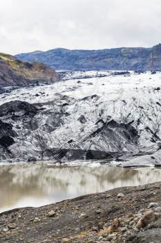 travel to Iceland - dirty Solheimajokull glacier (South glacial tongue of Myrdalsjokull ice cap) in Katla Geopark on Icelandic Atlantic South Coast in autumn