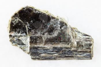 macro shooting of natural mineral rock specimen - raw muscovite mica stone on white marble background from Pirtima mine, Karelia, Russia