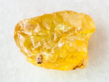 macro shooting of natural mineral rock specimen - raw crystal of sulphur stone on white marble background from Samara region, Russia