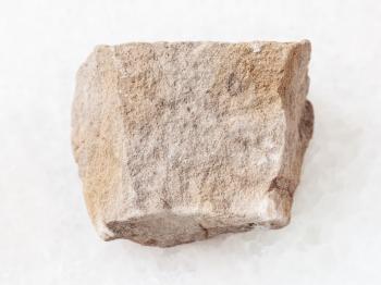 macro shooting of natural mineral rock specimen - rough gray Dolomite stone on white marble background