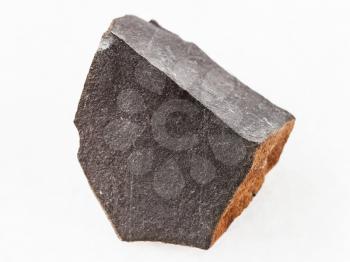 macro shooting of natural mineral rock specimen - raw hyalobasalt (tachylite) stone on white marble background