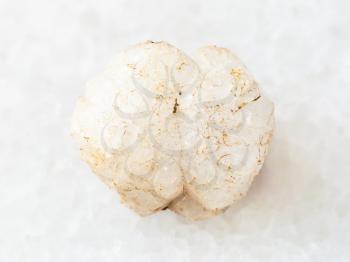 macro shooting of natural mineral rock specimen - raw crystal of analcime gemstone on white marble background from Khibiny Mountains, Kola Peninsula, Russia