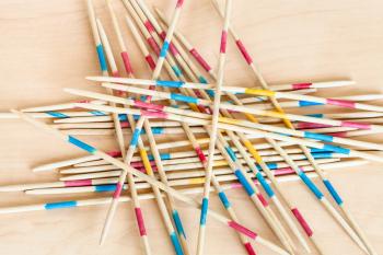 wooden sticks of Mikado pick-up sticks game close up on wood board