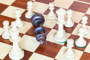 business concept - falling black chess king and wining white chess pieces
