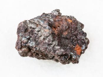 macro shooting of natural rock specimen - rough Goethite stone on white marble background from Tharsis, Spain