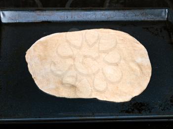 cooking of pie - flat raw dough on baking tray