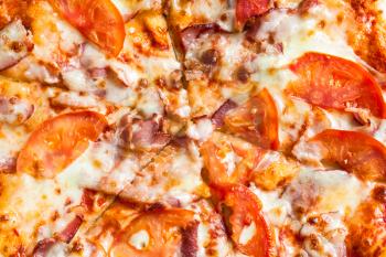 surface of Pizza with Bacon and Tomatoes close up