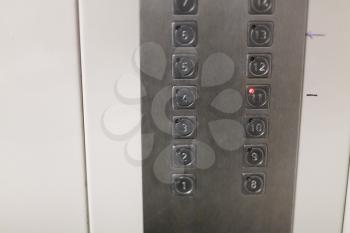 buttons in cabin of used elevator in urban apartment house