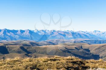 travel to North Caucasus region region - view of Caucasus mountain range from Bermamyt Plateau at autumn morning