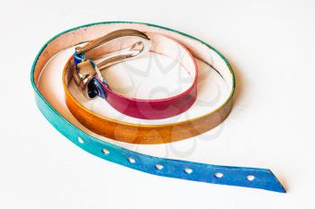 narrow varicoloured leather belt on white background