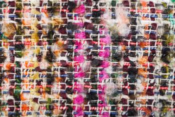 textile background - interlacing of color threads in boucle fabric close up